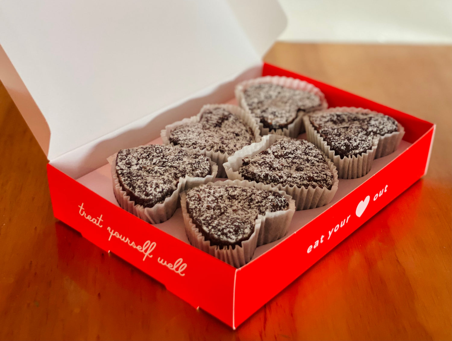 Red gift box with heart-shaped chocolate brownies for gift giving.