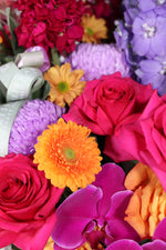 Luxury bright floral arrangement Brisbane CBD – modern vase with tropical and seasonal blooms in orange, hot pink and gold