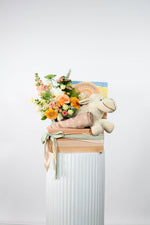 New Baby Gift basket with pastel flowers, bamboo wrap and plush Sheep toy.