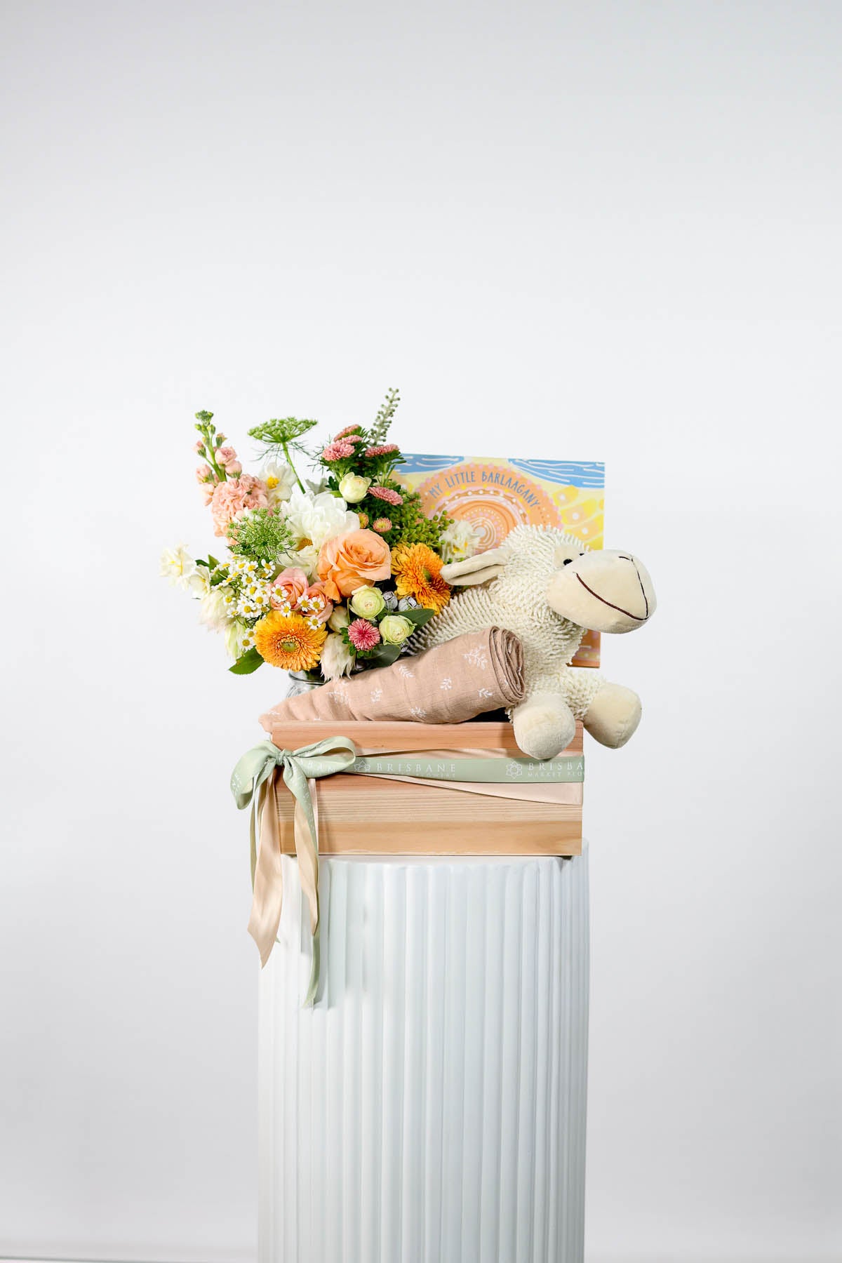 New Baby Gift basket with pastel flowers, bamboo wrap and plush Sheep toy.