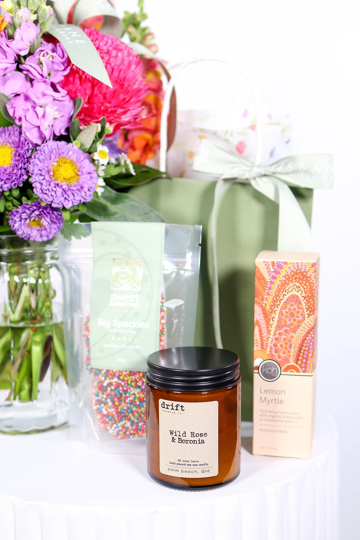 Candle, gift bag, and flowersfrom Brisbane Market Flowers.