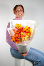 Poppy Wrap held by woman with bright mixed colourful blooms – Brisbane Market Flowers