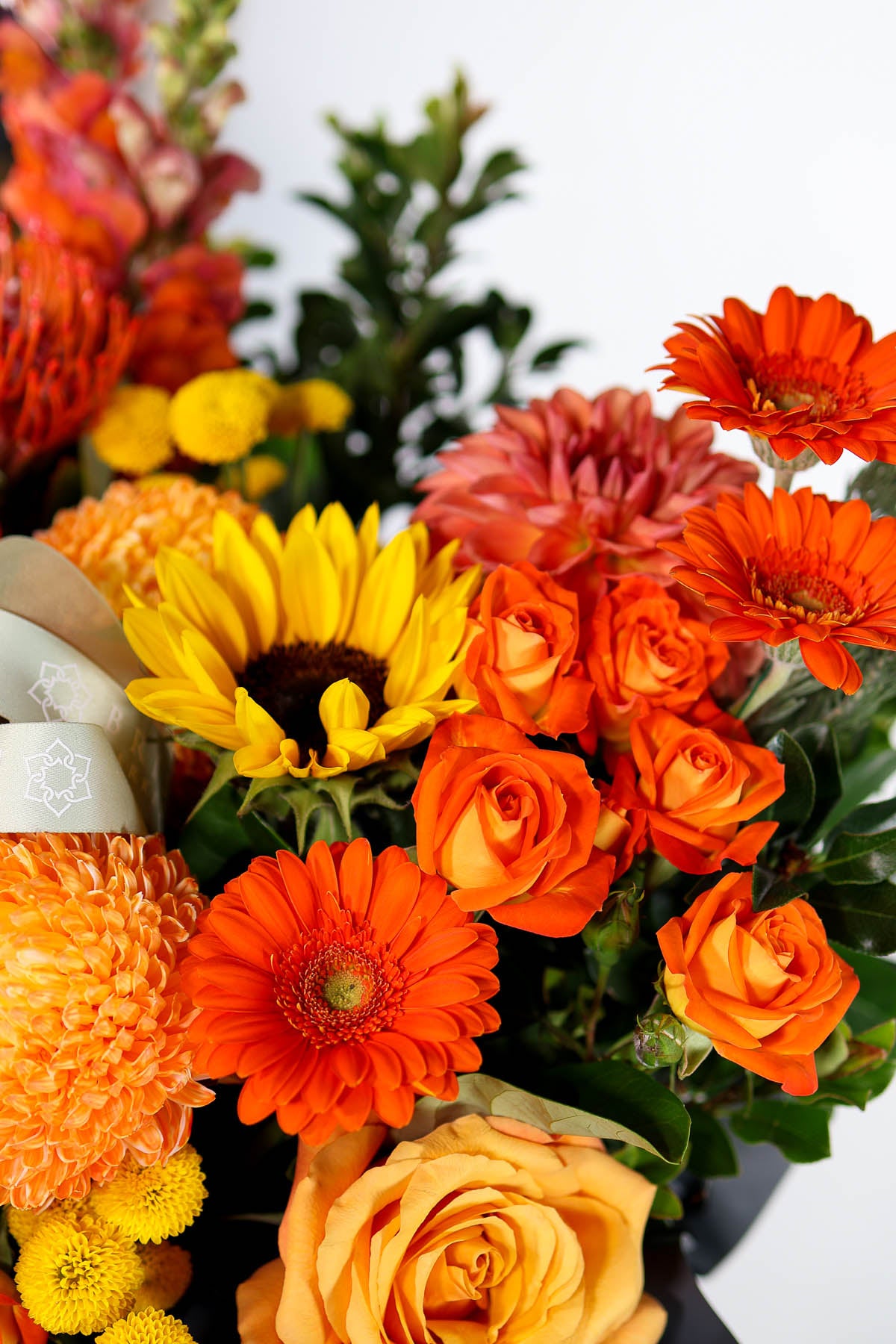 Bright orange flower arrangement with sunflowers for Brisbane delivery.