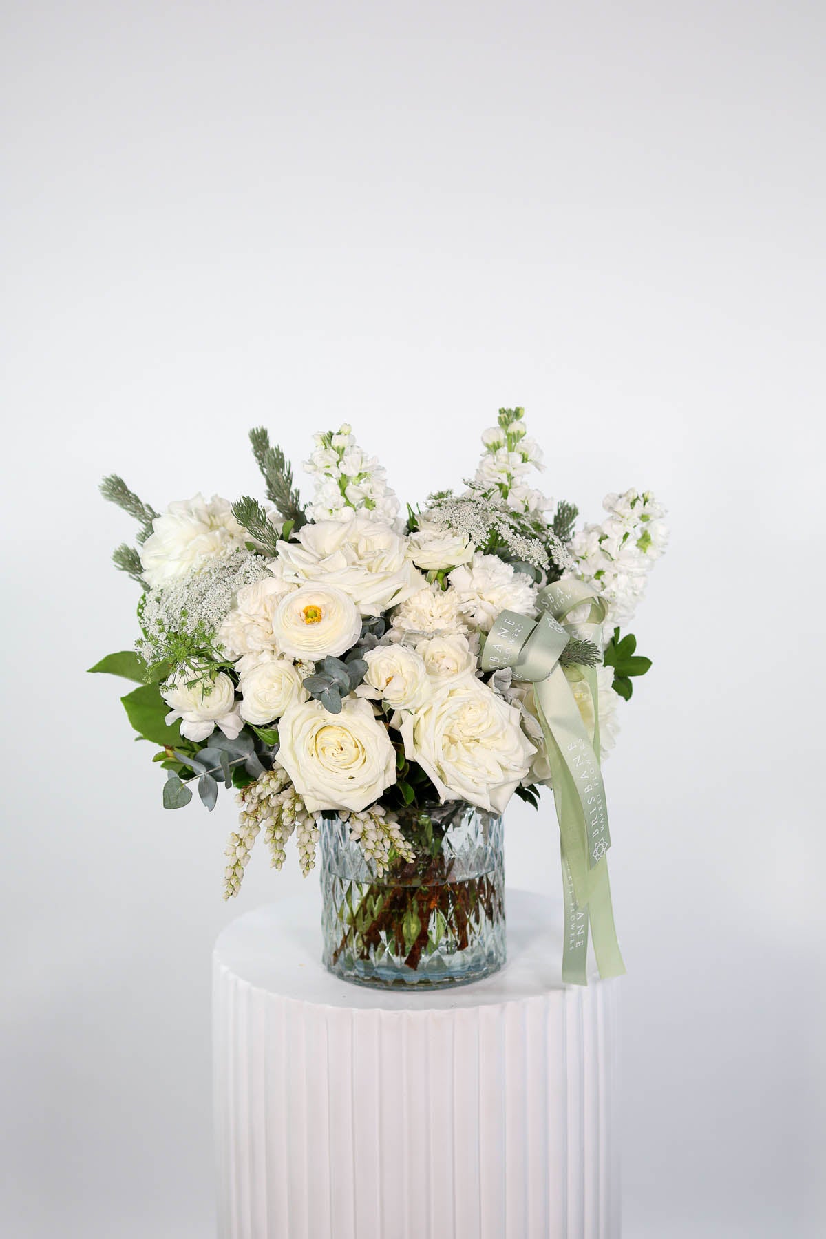 Elegant white vase arrangement by Brisbane Market Flowers featuring disbuds, dahlias, and roses