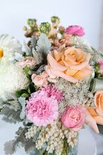 Hand-crafted pastel bouquet featuring pink disbuds, peach spray roses & andromeda accents