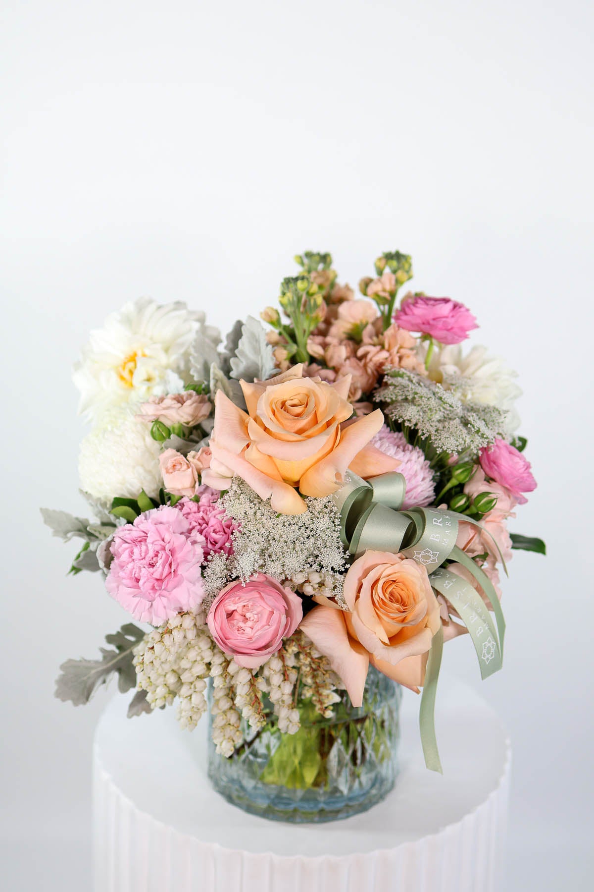 Luxury vase arrangement in pink & peach hues tied with BMF green ribbon & chiffon bow
