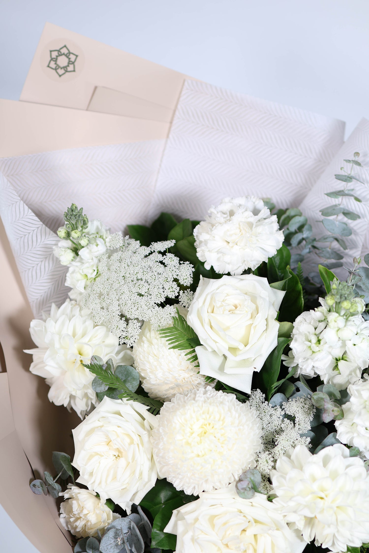 Bouquet of white flowers with greenery delivered in Brisbane same day.