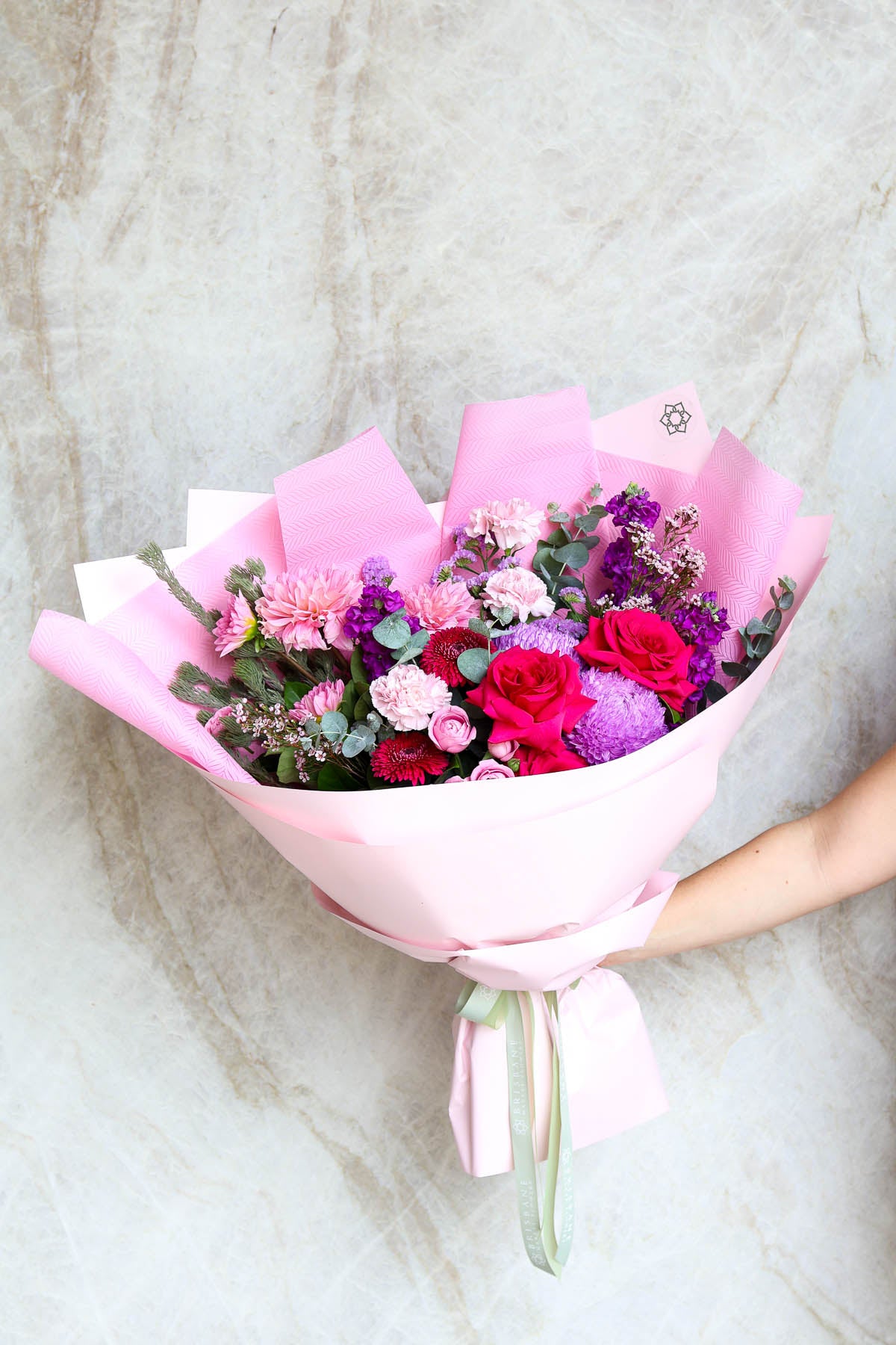 Wellington bouquet wrapped in layered pink cello and non-woven paper – luxury gift of pink seasonal blooms Brisbane