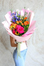 Vibrant flower bouquet held for graduation celebration, designed for special moments.