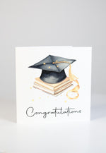 Graduation-themed card with books, cap and 'Congratulations'.