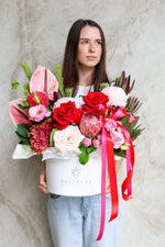 Sweet Romantic Valentine’s Day flower box with pink and red roses in white hatbox.