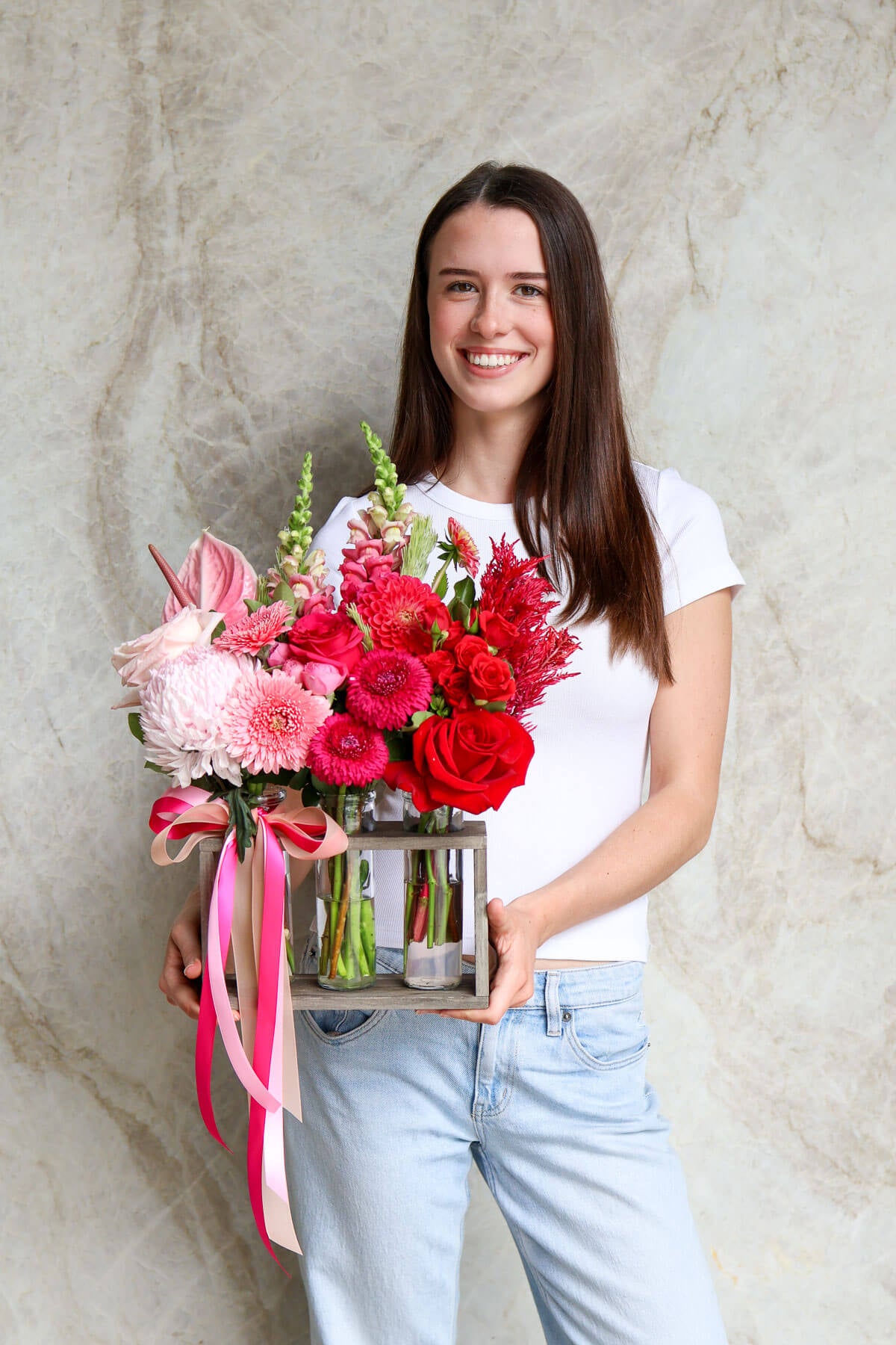 Woman holding a trio of vases for Valentine's Day.