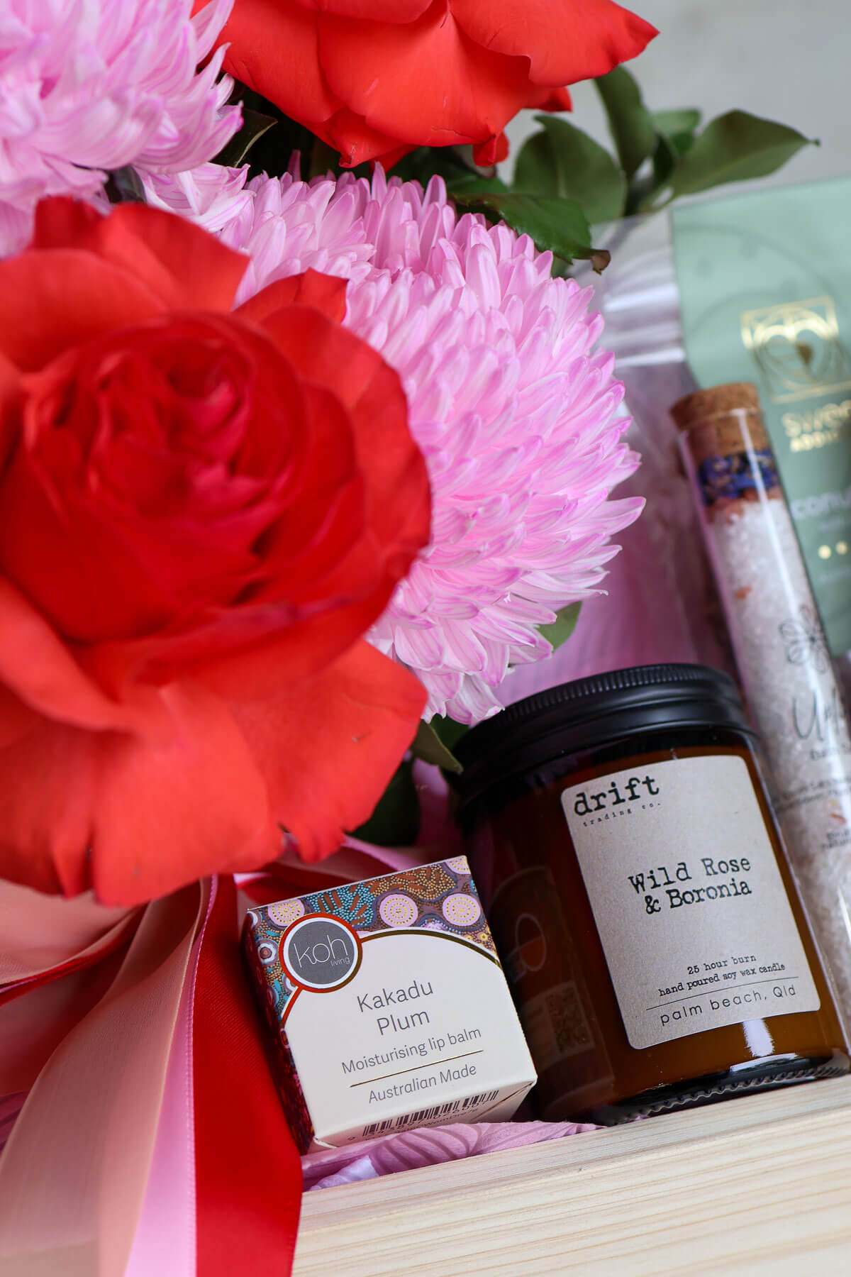 Valentine’s Day hamper with flowers lip balm candle chocolates and bath salts.