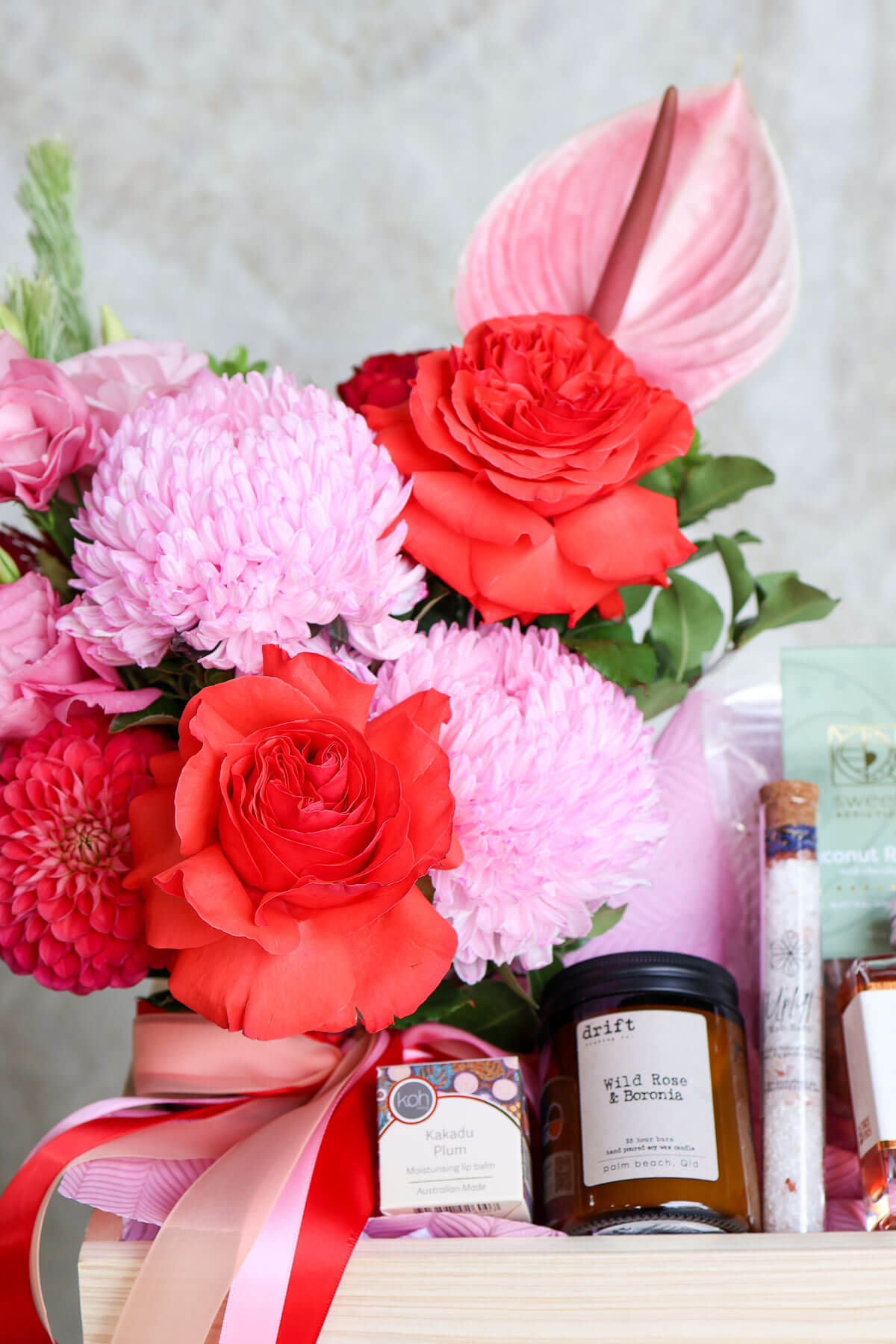 Elegant Valentine’s hamper with pink vase flowers and artisan treats.