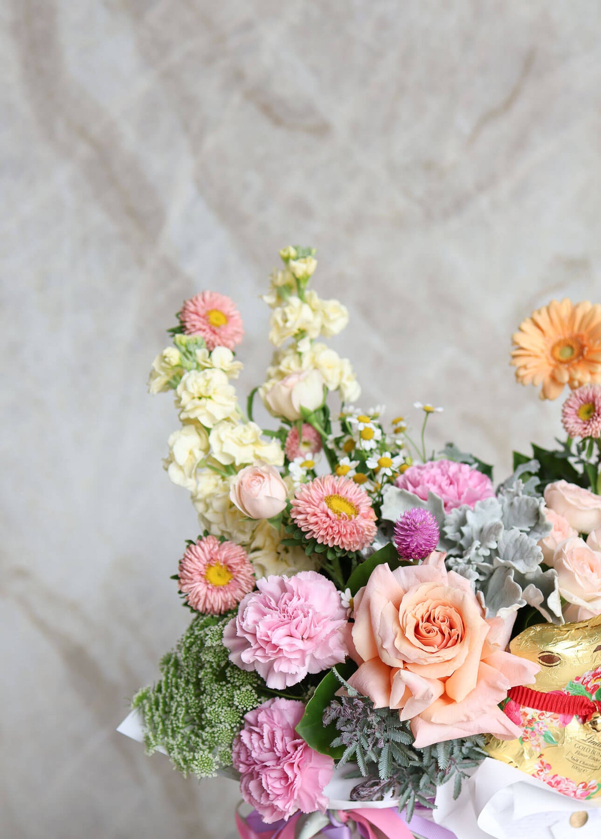 Whimsical spring Easter flowers in apricot mauve and lemon tones
