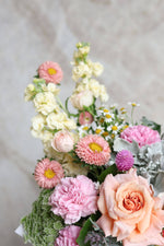 Close up of chamomile and roses in Easter gift basket
