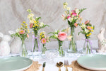 Easter table styled with six glass bud vases.
