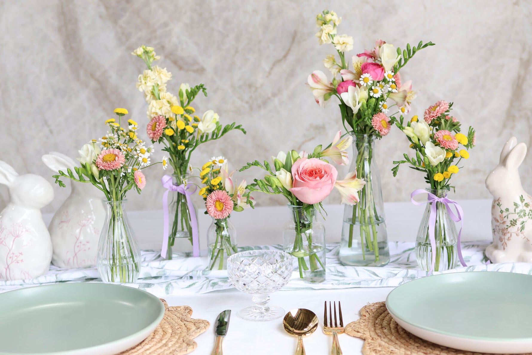 Easter table styled with six glass bud vases.