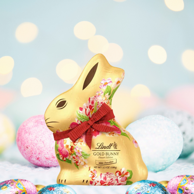 Lindt chocolate gold print Easter bunny 100g surrounded by easter eggs.