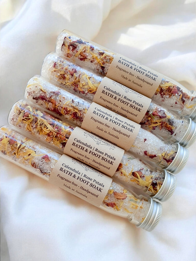 Multiple glass tubes of bath and foot soak with visible ingredients .