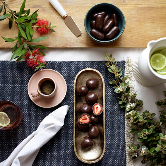 Table setting with chocolate-covered strawberries and coffee.
