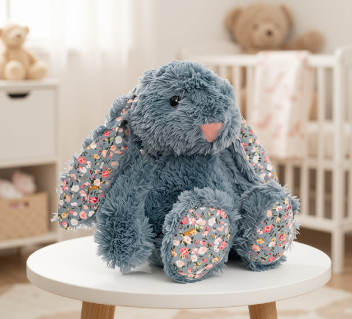 Dusty blue bunny plush with floral ears and feet.
