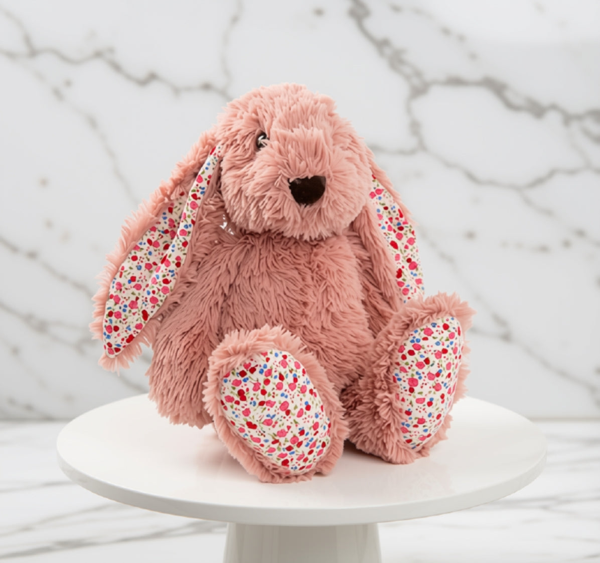 Dusty pink bunny plush with floral ears and feet.