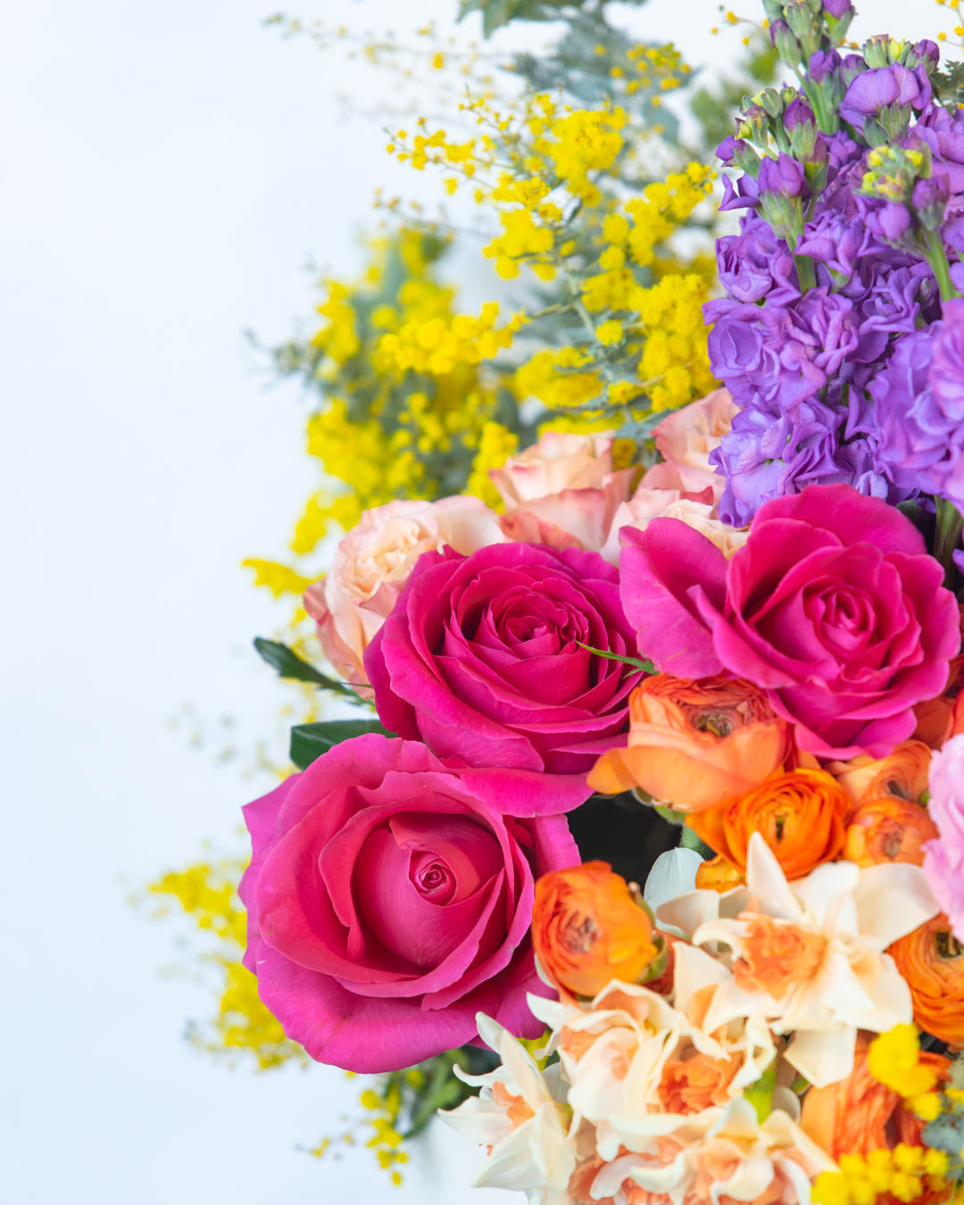 Bright colourful flowers in pink yellow and purple.