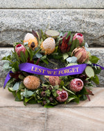 Brisbane florist Australian native and wildflower wreath with purple lest we forget ribbon.