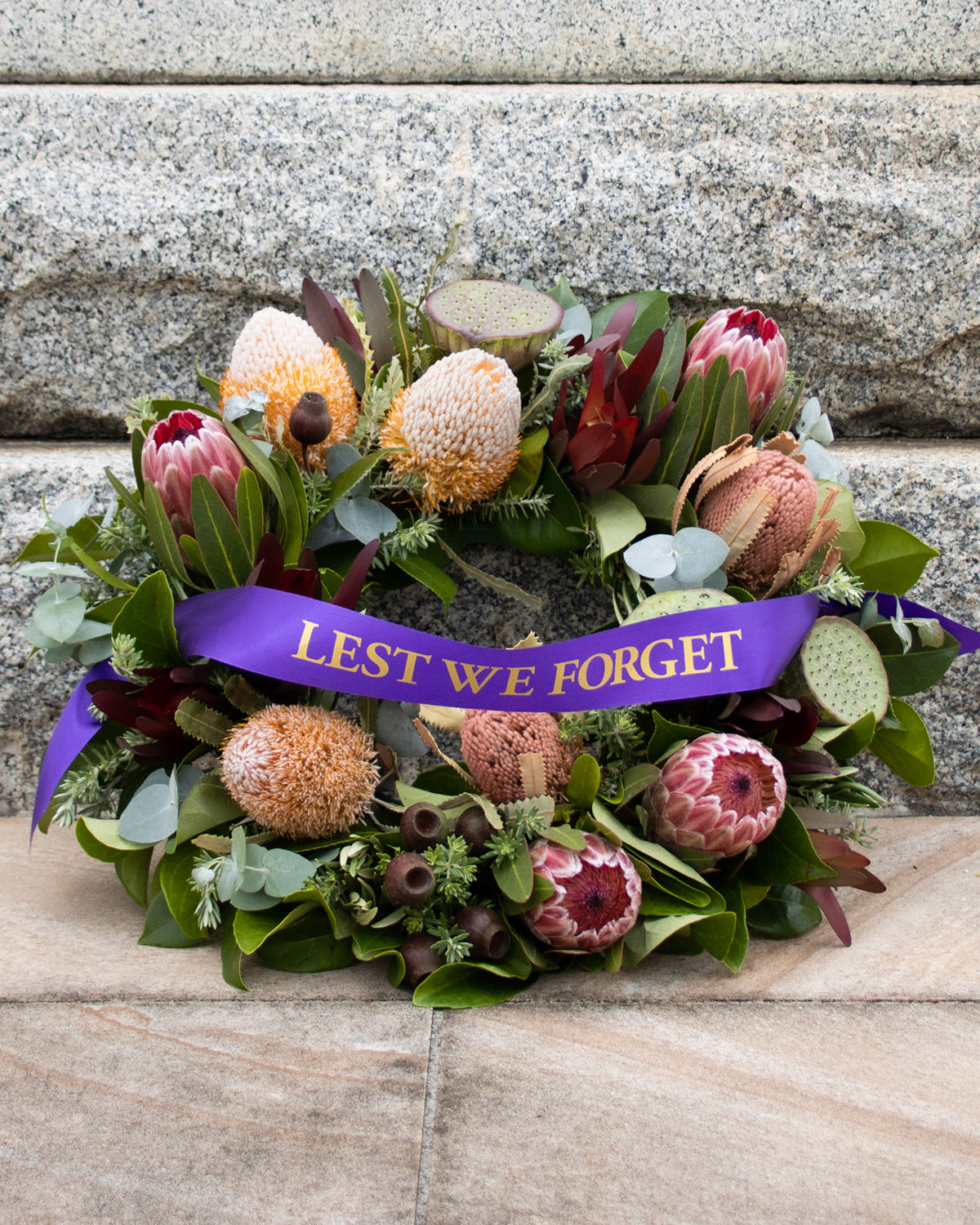 Brisbane florist Australian native and wildflower wreath with purple lest we forget ribbon.