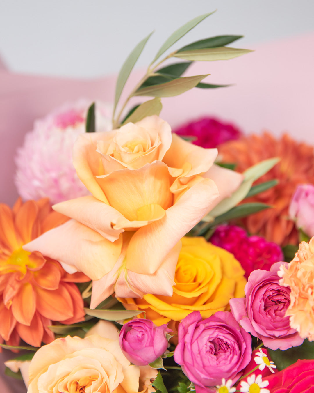 Close up of reflexed shimmer rose variety in bright summer bouquet of flowers.