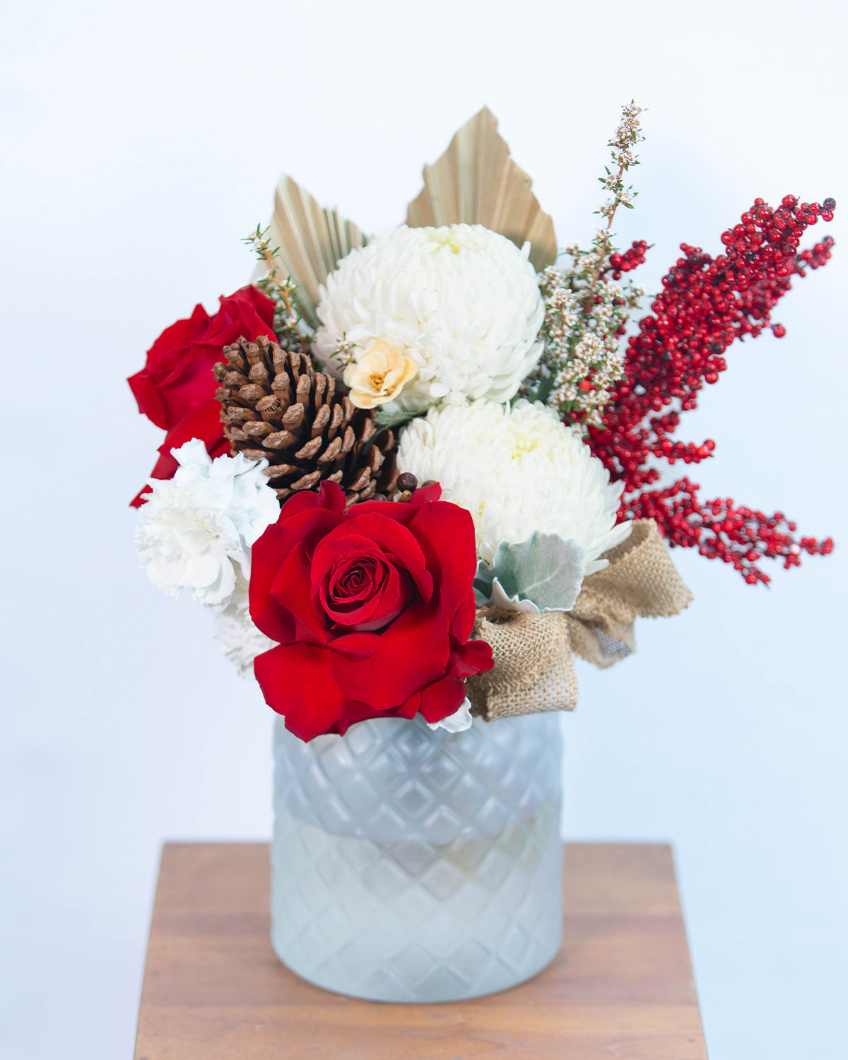 Noelle Christmas vase arrangement featuring red roses, white blooms, and festive foliage – Brisbane Market Flowers